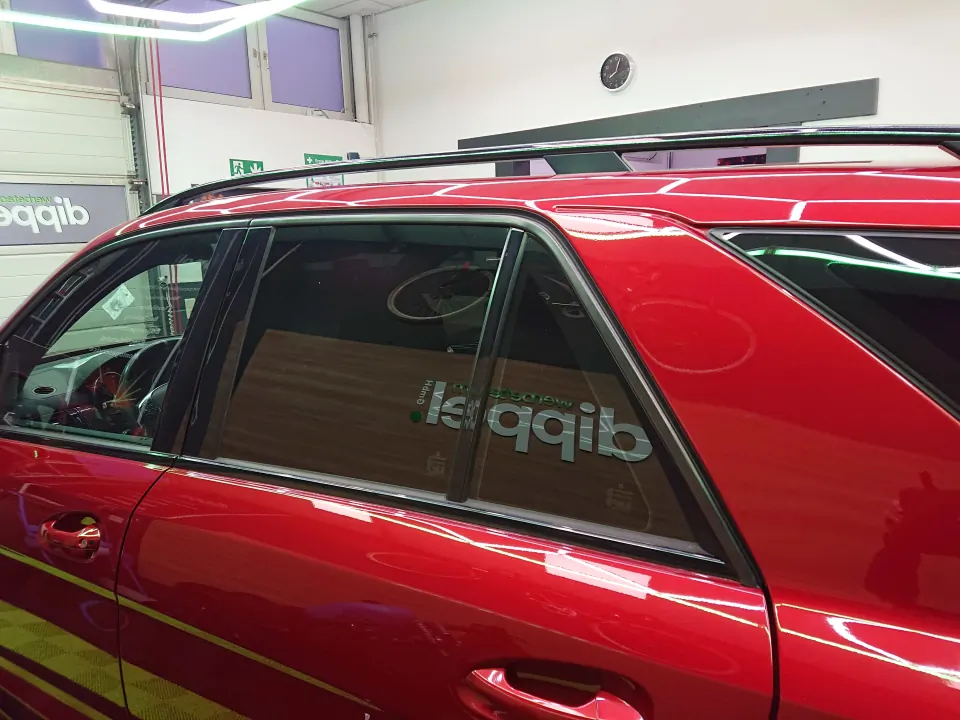 Chrome delete on a red Mercedes-AMG – side window chrome trims wrapped in gloss black